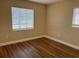 Bright bedroom with laminate flooring featuring two windows and a neutral paint scheme at 1601 Pontiac Ct, Orlando, FL 32808