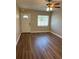 Inviting living room with new laminate flooring, a ceiling fan, and an updated front door at 1601 Pontiac Ct, Orlando, FL 32808