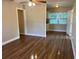 Open-concept living room with new floors offers a bright and airy feel. It leads to an updated kitchen at 1601 Pontiac Ct, Orlando, FL 32808