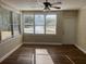 Bright living room features wood floors, a ceiling fan, and multiple windows, with a white front door entrance at 1601 Pontiac Ct, Orlando, FL 32808