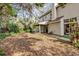 Large backyard with mature trees and a patio area at 1700 Bridlewalk Ct, Gotha, FL 34734