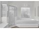 Bathroom with soaking tub, shower, and glass block window at 1700 Bridlewalk Ct, Gotha, FL 34734