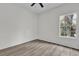 Bedroom with ceiling fan, large window and wood-look floors at 1700 Bridlewalk Ct, Gotha, FL 34734