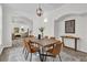 Elegant dining room with a wooden table and modern lighting at 1700 Bridlewalk Ct, Gotha, FL 34734