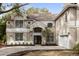 Two-story house with a neutral color palette and a three-car garage at 1700 Bridlewalk Ct, Gotha, FL 34734