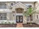 Front entrance of a home with double doors and a decorative tile walkway at 1700 Bridlewalk Ct, Gotha, FL 34734