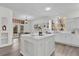 Modern kitchen with white cabinets and large island at 1700 Bridlewalk Ct, Gotha, FL 34734