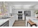 White kitchen with stainless steel appliances and quartz counters at 1700 Bridlewalk Ct, Gotha, FL 34734