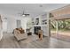 Living room with a fireplace, built-in shelving, and sliding glass doors to the backyard at 1700 Bridlewalk Ct, Gotha, FL 34734