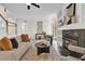 Living room with fireplace, built-in shelving, and access to a patio at 1700 Bridlewalk Ct, Gotha, FL 34734