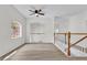 Bright loft area with wood-look floors, a ceiling fan, and a view to the lower level at 1700 Bridlewalk Ct, Gotha, FL 34734