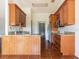 Kitchen with wood cabinets, granite countertops, and tile flooring at 1717 Minnow Ct, Poinciana, FL 34759