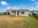 Covered patio in a backyard with a large lawn and privacy fence at 2514 Park Ridge St, Apopka, FL 32712