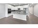 Modern kitchen with white cabinets, granite countertops, and stainless steel appliances at 2514 Park Ridge St, Apopka, FL 32712