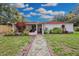 Landscaped backyard with stone path and spacious lawn at 2808 Touraine Ave, Orlando, FL 32812
