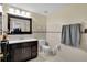 Updated bathroom with dark vanity, toilet and tiled flooring at 2808 Touraine Ave, Orlando, FL 32812