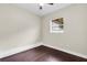 Simple bedroom with dark wood flooring and a window at 2808 Touraine Ave, Orlando, FL 32812