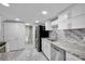 Modern kitchen with stainless steel appliances and granite counters at 2808 Touraine Ave, Orlando, FL 32812