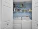 Convenient laundry room with washer, dryer, and storage shelves at 2808 Touraine Ave, Orlando, FL 32812