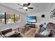 Living room with large window, brown couches, and tile floors at 2808 Touraine Ave, Orlando, FL 32812