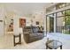 Open living room with tile floors, a gray sofa, bright lighting and a view of the outdoors at 2865 Palermo Ct, Orlando, FL 32806