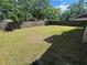 Large, grassy backyard enclosed by a wood fence, ideal for outdoor activities and entertaining at 3303 Jon Jon Dr, Orlando, FL 32822