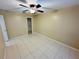 Bright bedroom featuring tile floors and a ceiling fan at 3303 Jon Jon Dr, Orlando, FL 32822