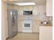 Kitchen with stainless steel appliances and light cabinets at 3303 Jon Jon Dr, Orlando, FL 32822