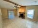 Living room with tile flooring and a stone fireplace at 3303 Jon Jon Dr, Orlando, FL 32822