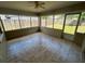 Tile-floored sun room with views of the fenced backyard and access to the outdoors at 3303 Jon Jon Dr, Orlando, FL 32822