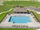 Overhead view of community pool, parking and playground surrounded by green space at 33425 Country House Dr, Sorrento, FL 32776