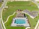 Aerial view of community pool, playground and parking in a new residential neighborhood at 33425 Country House Dr, Sorrento, FL 32776