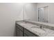 A stylish bathroom featuring double sinks, granite countertops, and a large mirror at 33425 Country House Dr, Sorrento, FL 32776