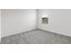 Neutral bedroom featuring gray carpet, white trim and a single window at 33425 Country House Dr, Sorrento, FL 32776