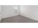 Neutral bedroom featuring gray carpet, white trim and a single window at 33425 Country House Dr, Sorrento, FL 32776