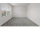 A bright bedroom featuring neutral walls, plush carpeting, and a window with natural light at 33425 Country House Dr, Sorrento, FL 32776