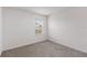 Small bedroom featuring carpeted floors, single window with blinds, and neutral walls at 33425 Country House Dr, Sorrento, FL 32776