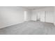 Large bedroom with gray carpet, white trim, and multiple doors and closets at 33425 Country House Dr, Sorrento, FL 32776