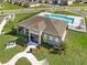 Charming clubhouse featuring a community pool, patio seating, and lush landscaping at 33425 Country House Dr, Sorrento, FL 32776
