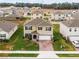 Two-story home featuring a neutral exterior, manicured lawn, brick paver driveway, and attached two-car garage at 33425 Country House Dr, Sorrento, FL 32776