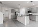 Modern kitchen with gray cabinets, granite countertops, stainless steel appliances, and an island with a sink at 33425 Country House Dr, Sorrento, FL 32776