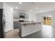 A modern kitchen with granite countertops, stainless steel appliances, and a central island at 33425 Country House Dr, Sorrento, FL 32776