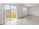 A bright living room featuring a large sliding glass door with backyard access and tile floors at 33425 Country House Dr, Sorrento, FL 32776