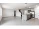 Spacious living area showcases a kitchen island, open floor plan, staircase and modern neutral colors at 33425 Country House Dr, Sorrento, FL 32776