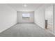 Main bedroom with gray carpet, white trim, window and door to bathroom and closet at 33425 Country House Dr, Sorrento, FL 32776