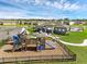 Community playground with two slides, climbing wall, and turrets near the clubhouse and pool at 33425 Country House Dr, Sorrento, FL 32776