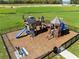 New community playground with slides, climbing wall, and turrets surrounded by a black metal fence at 33425 Country House Dr, Sorrento, FL 32776