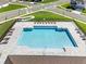 Aerial view of a sparkling community pool surrounded by lounge chairs and a paved deck at 33425 Country House Dr, Sorrento, FL 32776