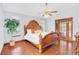 Main bedroom with wood floors and a large wooden bed frame at 340 Plantation Club Dr, Debary, FL 32713