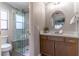 Modern bathroom with updated vanity, a walk-in shower, and a frameless glass enclosure at 400 Magnolia Oak Dr, Longwood, FL 32779
